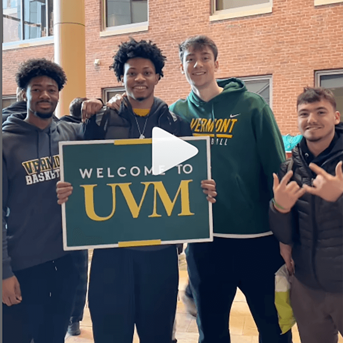 Students hold a sign that says Welcome to UVM
