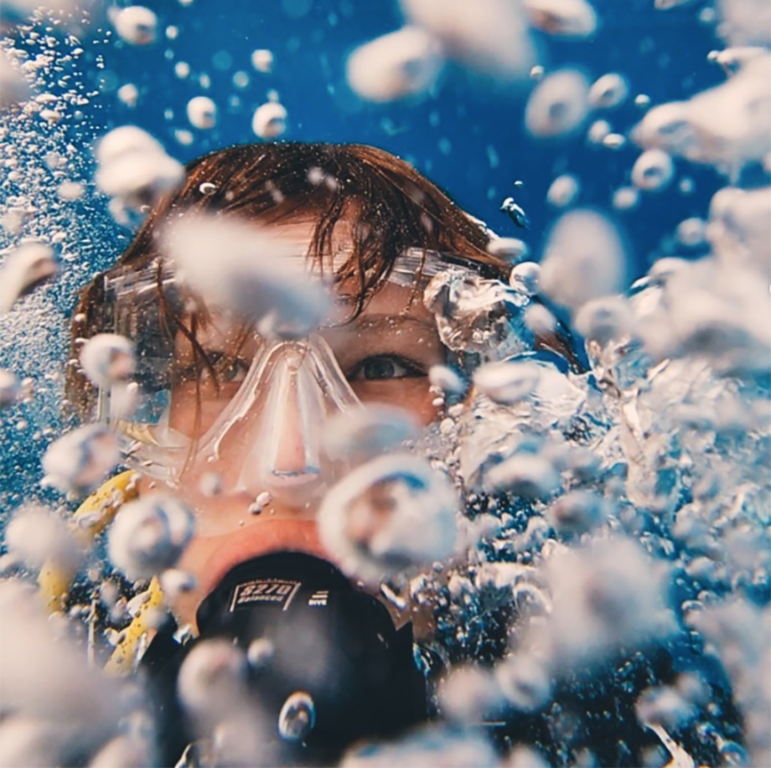 Underwater view of a person wearing a scuba mask