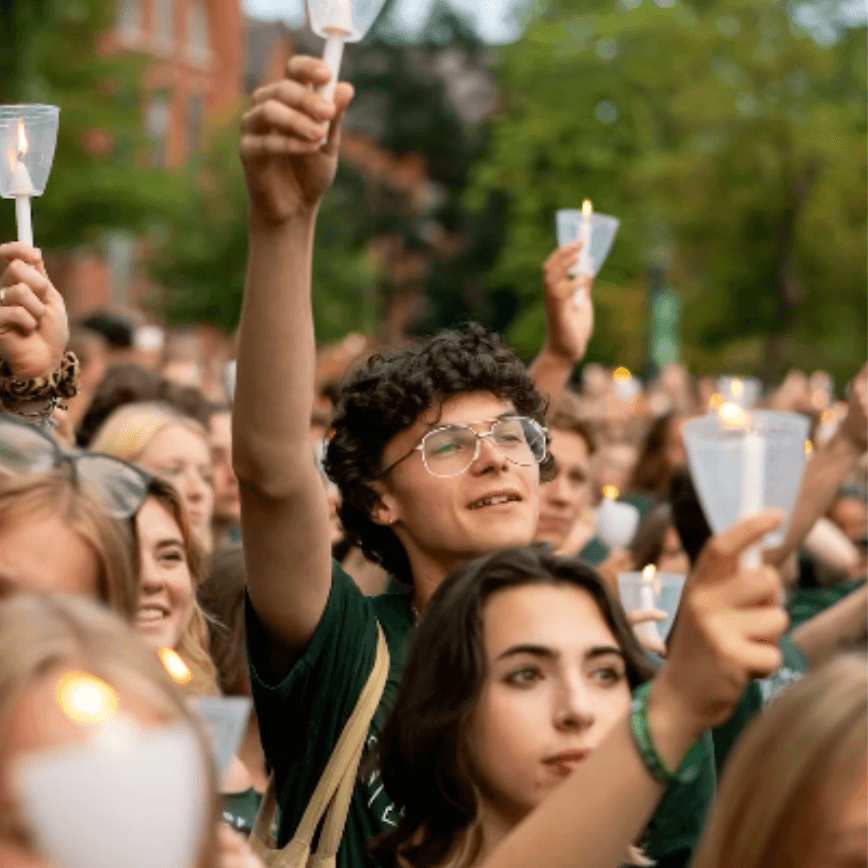 Group of students raises candles at convocation