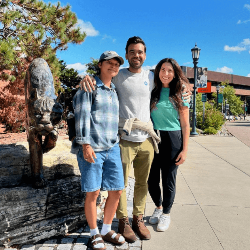 A family poses together near the Catamount statue