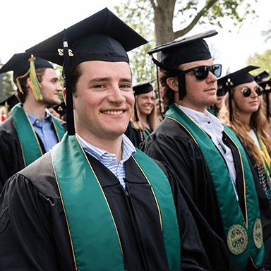 Smiling male graduates.
